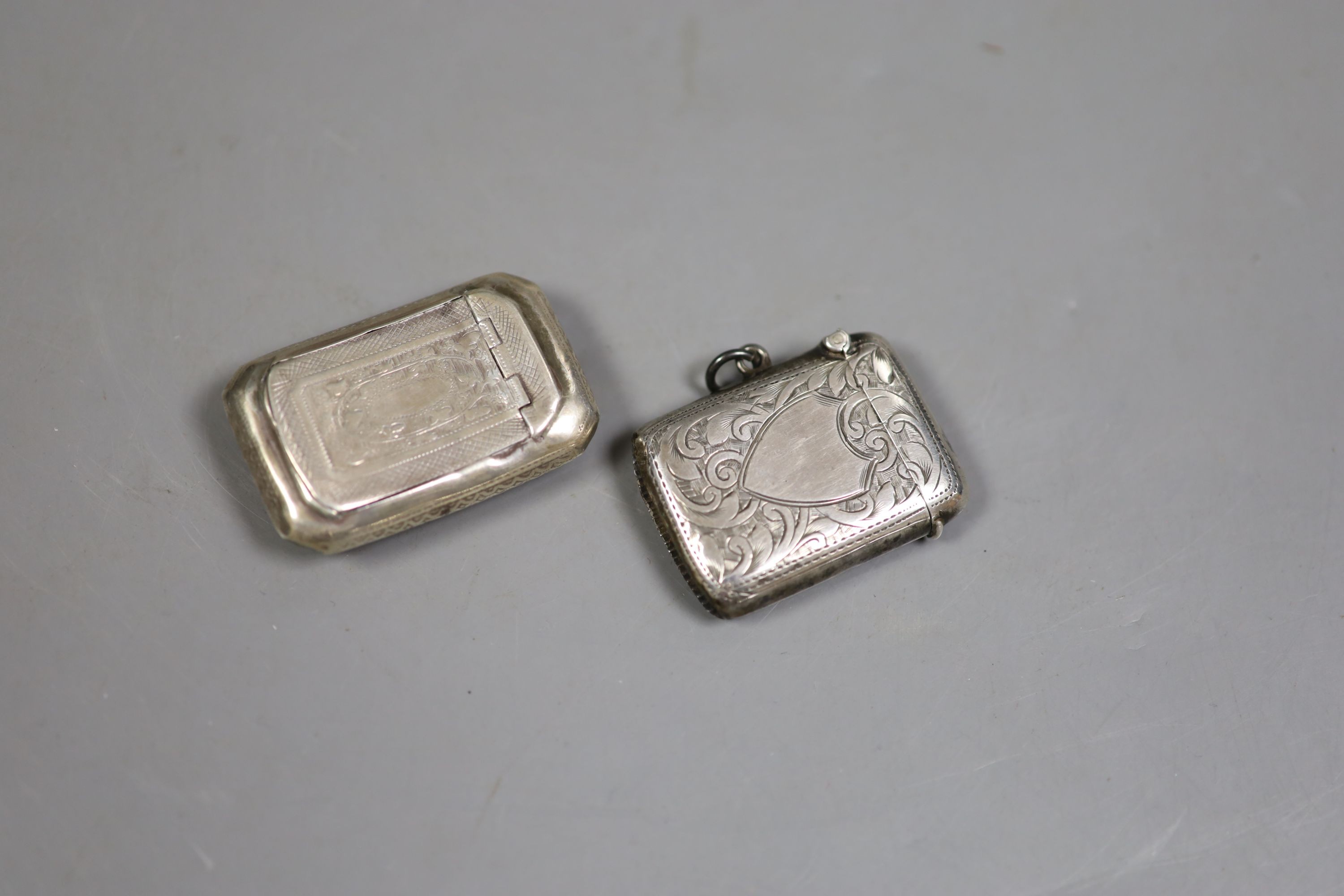 A George III silver curved snuff box, Birmingham, 1813, 52mm, a silver vesta case and two metal pill boxes